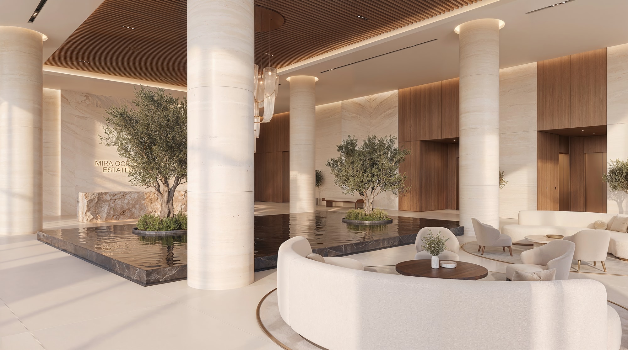 The double-height residential lobby with a chandelier and lounge seating
