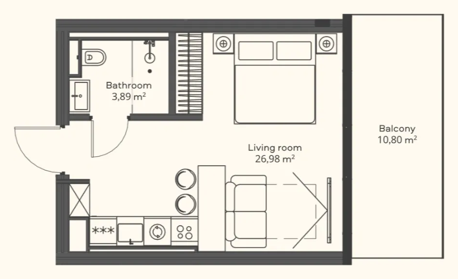 Floor plan of a Trussardi Residences studio: an L-shaped living room with the bed on the balcony side, a kitchen along the inner wall, a bathroom off the entrance, and a wide balcony
